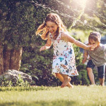 Kids playing with sprinkler